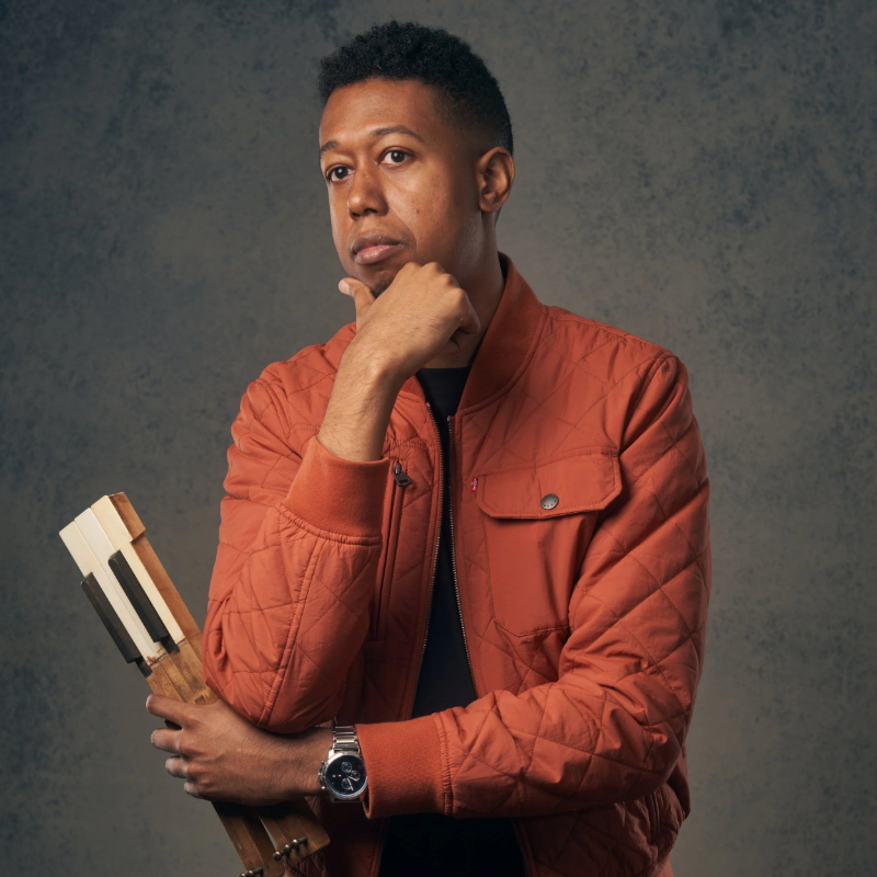 Lawrence Fields portrait in a rust-colored jacket